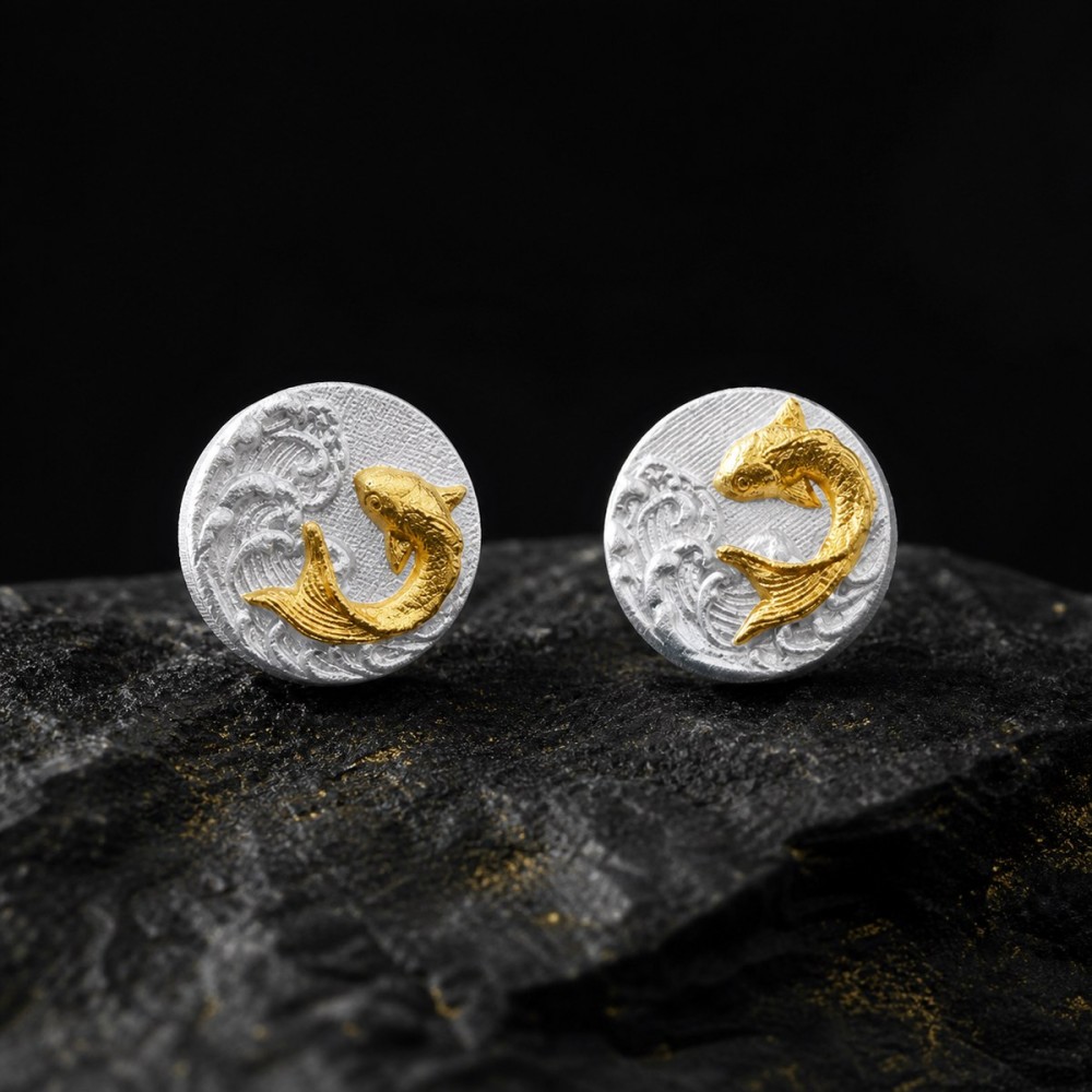 Koi fish stud earrings in fine silver with gold details arranged as a directional pair