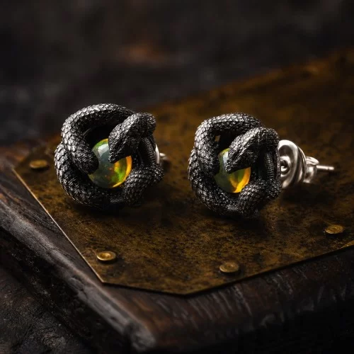 Oxidized sterling silver snake stud earrings with natural opal and gold-colored details