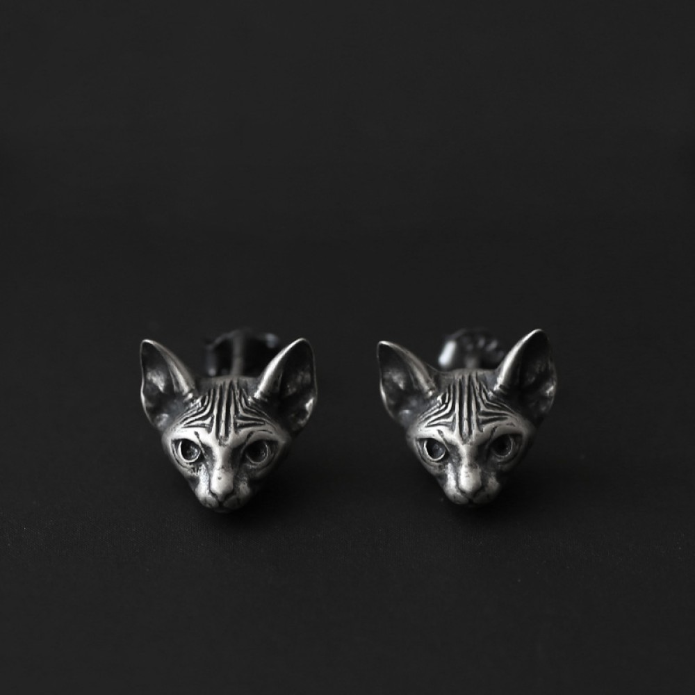 Front view of sculptural cat stud earrings described as 925 sterling silver