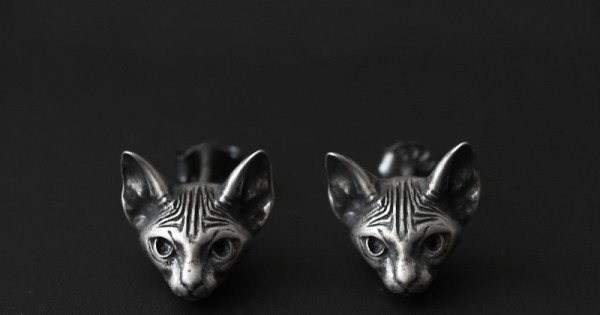 Pair of 925 sterling silver Sphynx cat stud earrings with polished faces and darkened details