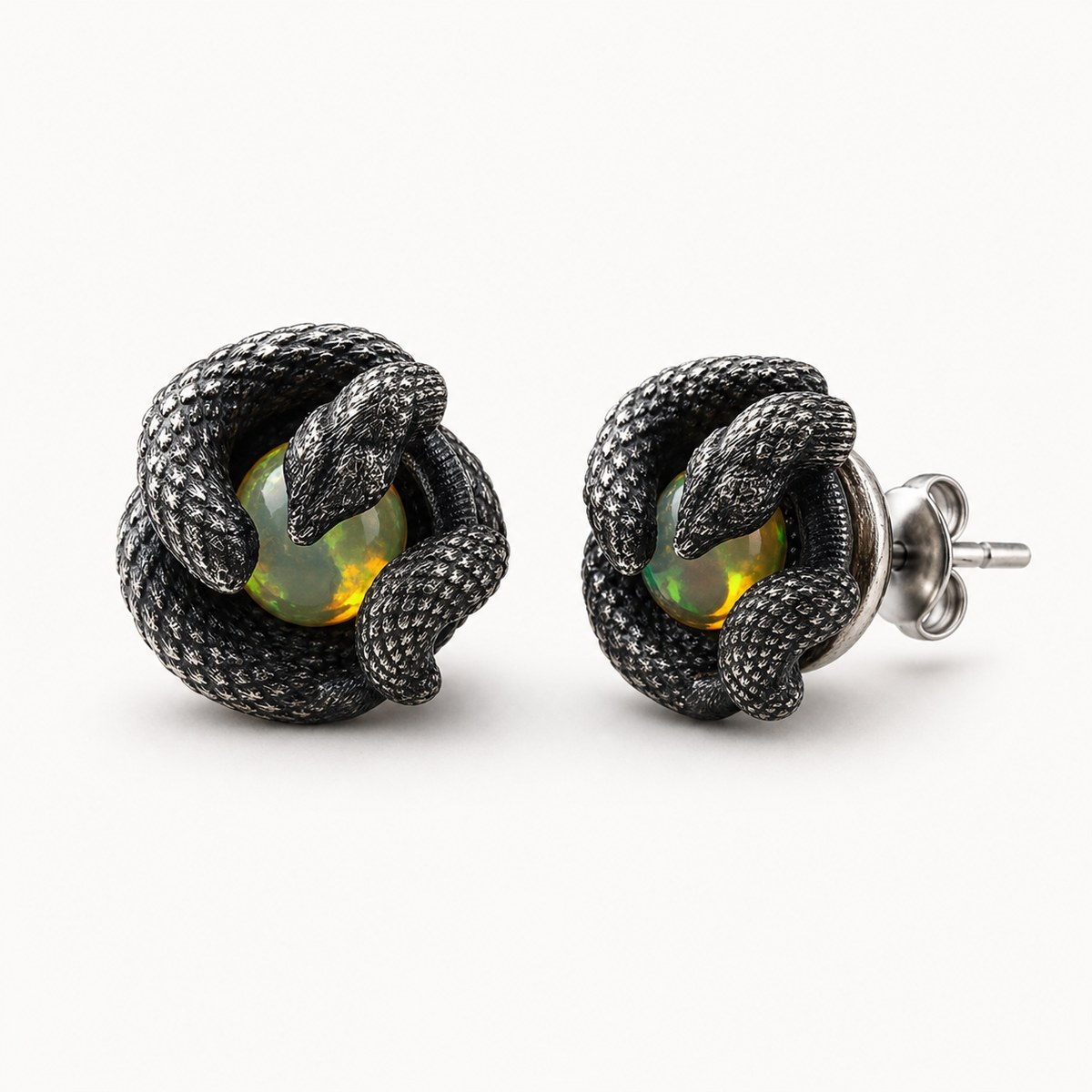 Close detail of natural opal inside an oxidized silver serpent setting